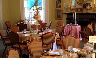 a dining room with tables set for a formal dinner , featuring elegant decorations and elegant furniture at The Martha Washington Inn and Spa