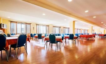 a large , empty banquet hall with multiple dining tables and chairs arranged for a conference or event at La Cañada