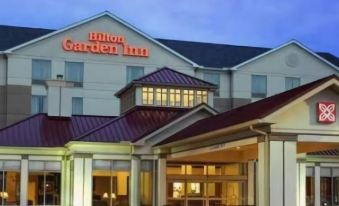 the exterior of a hilton garden inn hotel , with its red roof and white exterior , under a blue sky at Hilton Garden Inn Bristol