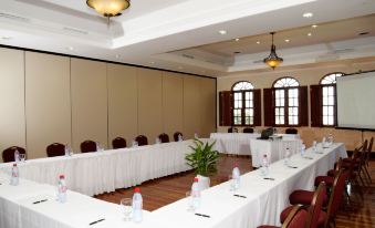 a large conference room set up for a meeting , with multiple tables and chairs arranged in rows at The Crane Resort