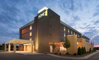 "a modern hotel building with the word "" home 2 "" prominently displayed on its sign , surrounded by trees and other buildings" at Home2 Suites by Hilton Milwaukee Brookfield