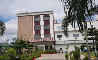 "a large hotel with a sign that reads "" leisure resort "" prominently displayed on the front of the building" at Leisure Resort