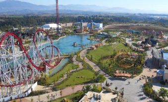 an aerial view of a large amusement park with a ferris wheel , water park , and other attractions at Magic Rainbow