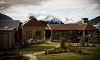 a beautiful mountain landscape with a small village in the background , surrounded by lush green grass and trees at The Headwaters Eco Lodge