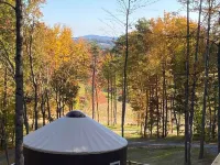 Elevated eclectic yurt with wrap-around porch, hot tub, and mountain view! Hotels in Piper Gap