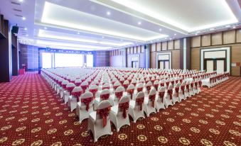 a large conference room with rows of white chairs arranged in an orderly fashion , ready for an event at Muong Thanh Grand Hoang Mai - Nghe An