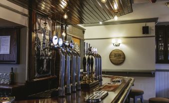 a bar with multiple beer taps , creating a cozy atmosphere and inviting atmosphere for patrons at The Bulls Head
