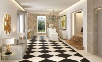 a black and white checkered floor in a hallway with a window , chandelier , and stairs at Bordoy Continental Valldemossa