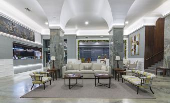 a large room with multiple couches , chairs , and tables arranged in a seating area at Hotel Bahía de Vigo