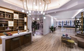 The spacious room features wooden floors and a ceiling, seamlessly connected to the living area at Mercure Shanghai Yu Garden On the Bund