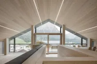 A beautiful wood and glass chalet at the edge of the Forest Hotels in Santo Stefano di Cadore