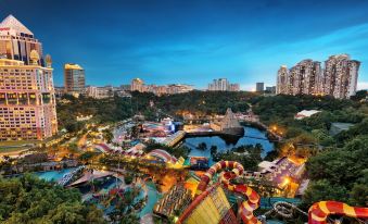 a large amusement park with various rides and attractions , including a ferris wheel and a water slide at Sunway Lagoon Hotel , Formerly Sunway Clio Hotel
