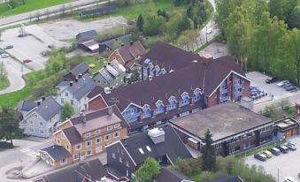 an aerial view of a large building complex with multiple buildings and roads surrounding it at Thon Hotel Hallingdal