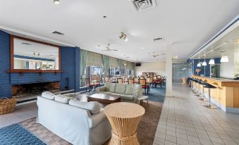 a spacious living room with multiple couches and chairs , creating a comfortable and inviting atmosphere at Scamander Beach Resort