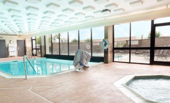 an indoor swimming pool with a view of the ocean , surrounded by a large building at Drury Inn & Suites Atlanta Morrow