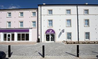 "a building with a purple sign that says "" p hotel "" has a pink and white facade" at Penrith