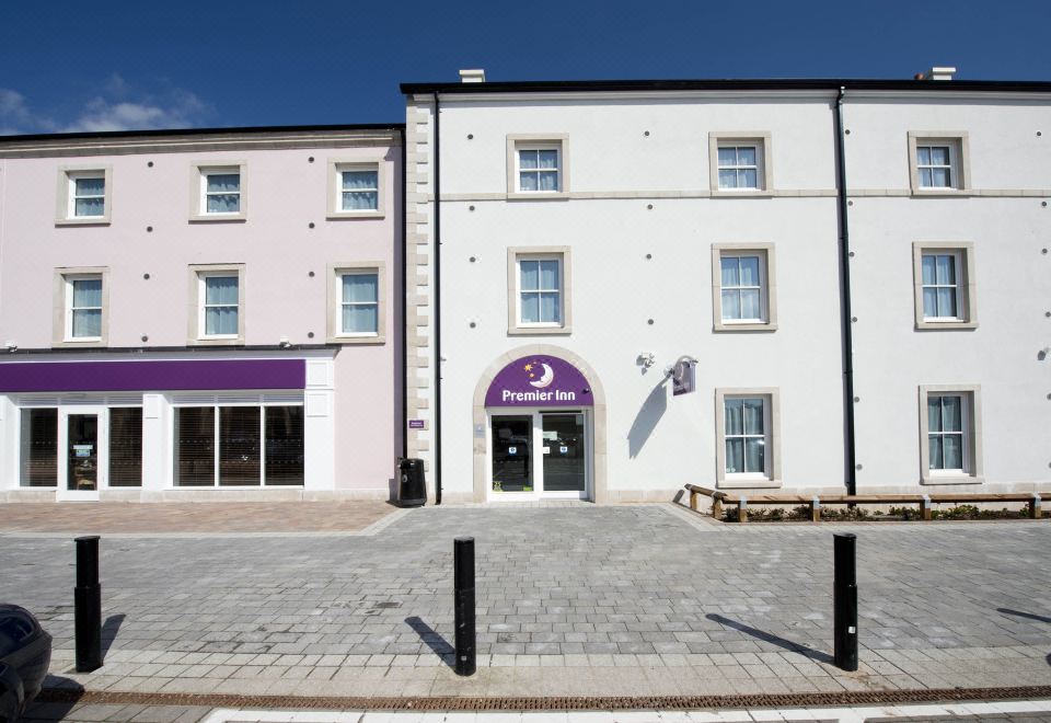 "a building with a purple sign that says "" p hotel "" has a pink and white facade" at Penrith