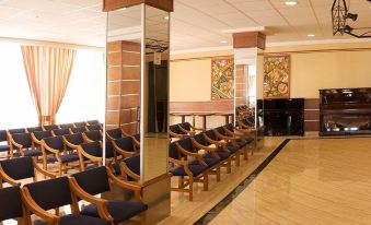 a large room with multiple rows of chairs arranged in a semicircle , possibly for a conference or meeting at Hotel Las Arenas