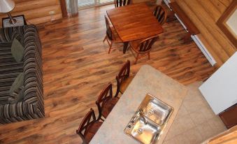 a dining area with a wooden table and chairs , as well as a kitchen with stainless steel appliances at Beaver Lake Resort