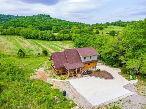 Gorgeous custom log cabin on 185 acres