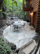 Cozy log cabin secluded in a mountain forest with hot tub, sauna, private patio.