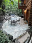 Cozy log cabin secluded in a mountain forest with hot tub, sauna, private patio.
