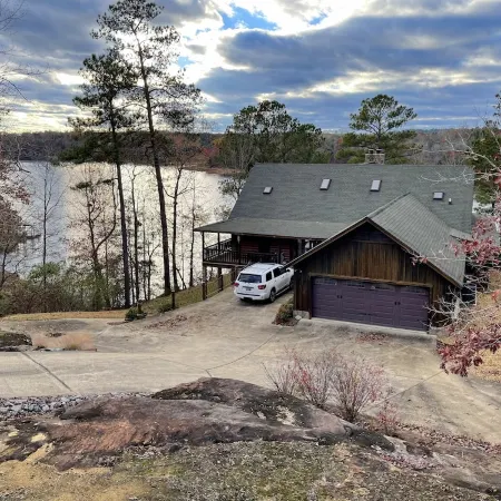 Large six-bedroom loghome w/ private boat ramp, dock, movie room and pool room.