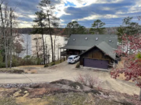 Large six-bedroom loghome w/ private boat ramp, dock, movie room and pool room.