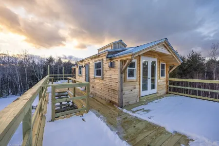 Insanely romantic treehouse perched next to a stream and rolling hills.