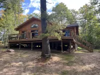 Timber cottage with large deck overlooking the water. Boat access only, no road.