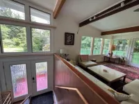 Private mid-century modern hideaway in forest near the river and sea.