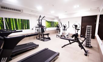 a well - equipped gym with various exercise equipment , such as treadmills , weight machines , and benches , arranged in a neat and organized manner at Hotel Diament Zabrze - Gliwice