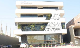 "a modern building with a white exterior and black accents , featuring the words "" heritage "" on the front" at The Heritage