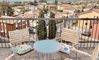 a balcony overlooking a small town , with several chairs and a table placed on the balcony at Green Park Hotel