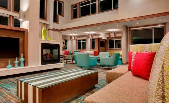 a spacious living room with multiple couches and chairs , creating a comfortable and inviting atmosphere at Residence Inn Kingston