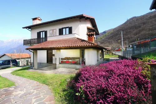 Large apartment with covered outdoor patio with table and barbecue.