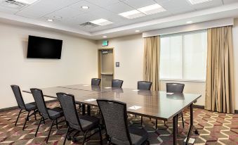 a conference room with a long table , chairs , and a tv mounted on the wall at Residence Inn Riverside Moreno Valley
