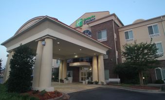 "a large , well - maintained hotel building with a covered entrance and a sign that reads "" holiday inn express .""." at Holiday Inn Express Pembroke