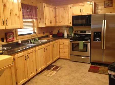 3BR 2 Bath house with full kitchen, living room, and hot tub.