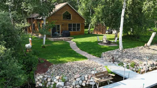 Spacious Summer Escape: Private Backyard, Dock & Fire Pit, Channel Waterfront
