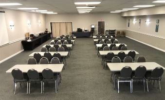 a large conference room with rows of chairs arranged in a semicircle around a table at Thriftlodge Kingston