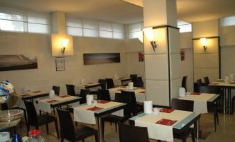 a dining room with tables and chairs arranged for a group of people to enjoy a meal together at Hotel Kristall