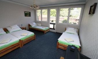 a room with three beds , two of which are twin beds and one is a double bed at Waterfront