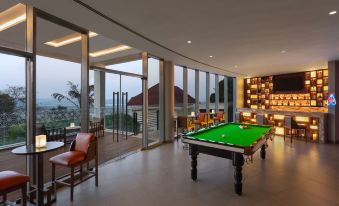 a large room with a pool table , bar area , and dining table , all surrounded by chairs at DoubleTree by Hilton Goa - Panaji