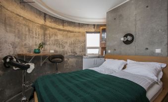 a bedroom with a round bed and a flat screen tv mounted on the wall at Klettar Tower Iceland