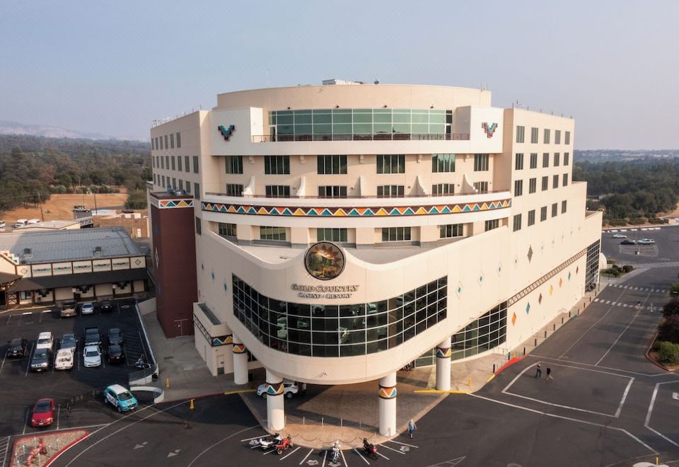 an aerial view of a large white building with a large glass window and colorful accents at Gold Country Casino Resort