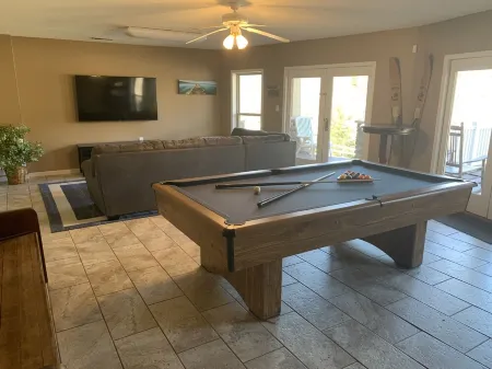 Lakehouse with covered dock, slide, and outdoor kitchen! Close to I-75, trails.