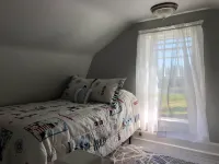 Rustic vintage cottage in Duck Cove with limited ocean view.