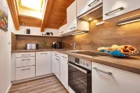 Cozy 65 sqm attic apartment with open roof truss and two balconies