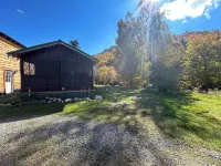 Classic original cedar log cabins set on Simms Stream in the North East Kingdom.